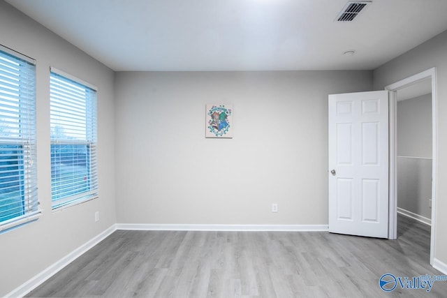 unfurnished room with light hardwood / wood-style flooring