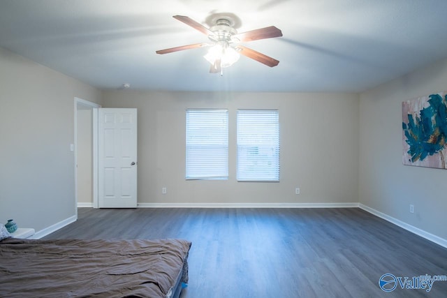 unfurnished bedroom with dark wood-type flooring and ceiling fan