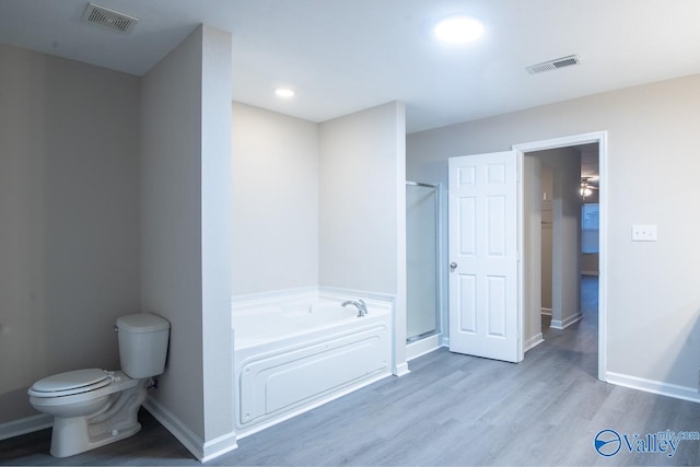 bathroom featuring hardwood / wood-style flooring, independent shower and bath, and toilet