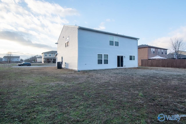 rear view of property with central AC