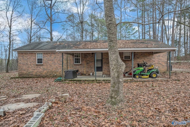 rear view of house with a patio area and central AC