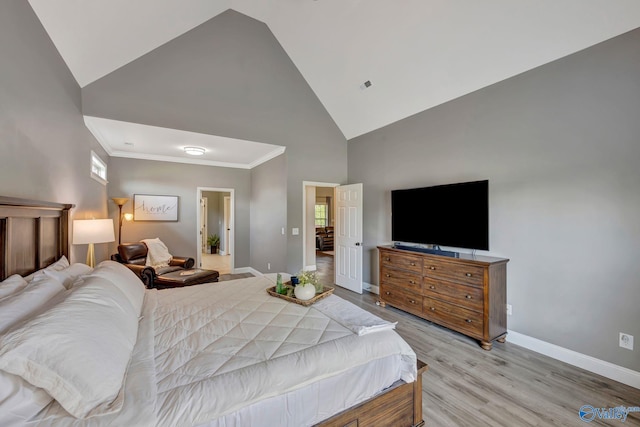 bedroom featuring high vaulted ceiling, light wood-type flooring, visible vents, baseboards, and ornamental molding