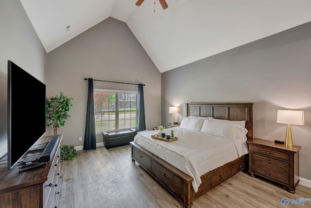 bedroom featuring light wood-style flooring, baseboards, ceiling fan, and high vaulted ceiling