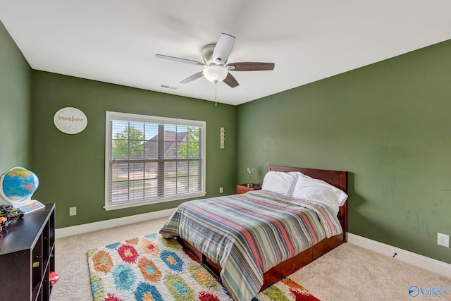 carpeted bedroom featuring baseboards, visible vents, and ceiling fan