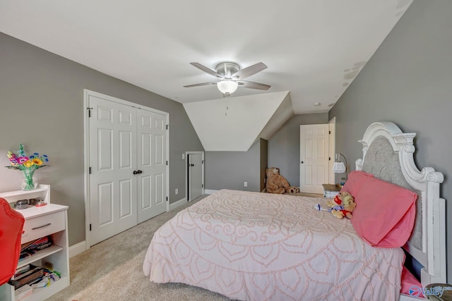 carpeted bedroom with vaulted ceiling, ceiling fan, a closet, and baseboards