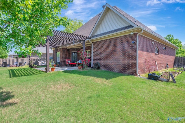 rear view of house with a pergola, fence private yard, a yard, brick siding, and a patio area