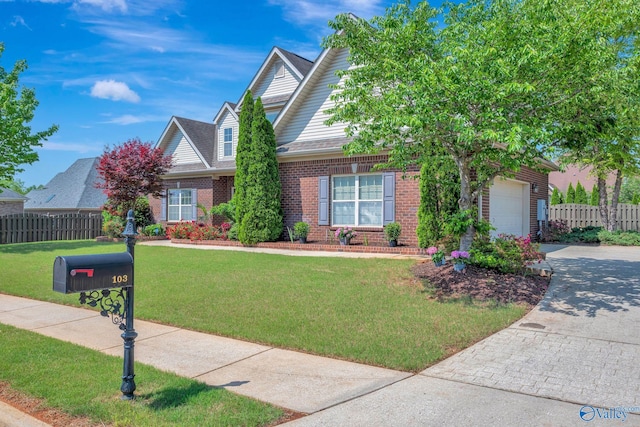 view of front of home with fence, an attached garage, brick siding, driveway, and a front lawn