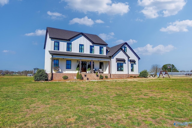 modern farmhouse featuring covered porch, a front lawn, board and batten siding, and a shingled roof