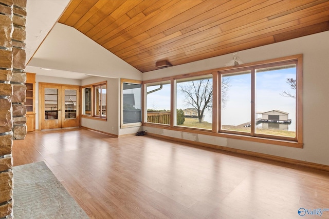 unfurnished living room with wood ceiling, wood-type flooring, and vaulted ceiling