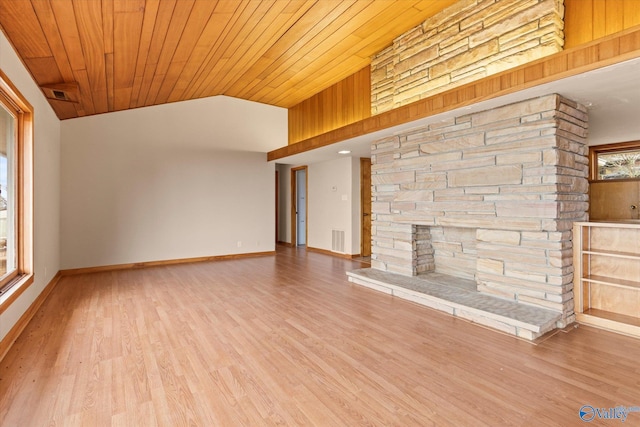 unfurnished living room featuring a stone fireplace, wooden ceiling, lofted ceiling, and light wood-type flooring