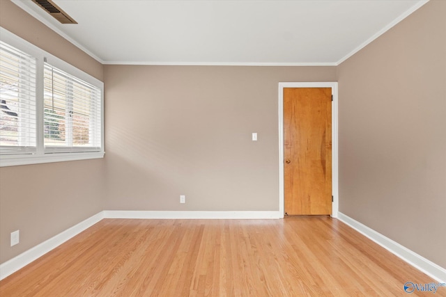 unfurnished room featuring light hardwood / wood-style flooring and ornamental molding