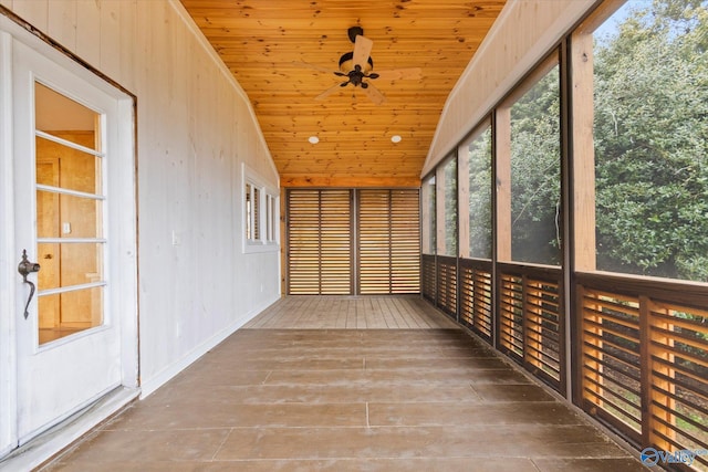 unfurnished sunroom with lofted ceiling, ceiling fan, and wooden ceiling