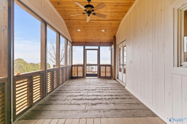 unfurnished sunroom featuring ceiling fan, wood ceiling, and vaulted ceiling