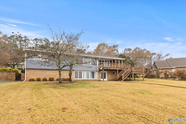 rear view of house with a yard and a deck