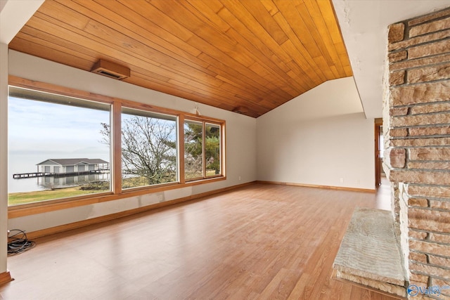 unfurnished living room with light hardwood / wood-style floors, vaulted ceiling, and wood ceiling