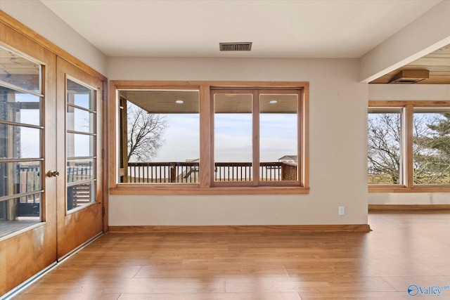 unfurnished sunroom with french doors