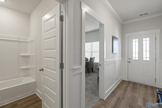 foyer featuring dark hardwood / wood-style floors and crown molding