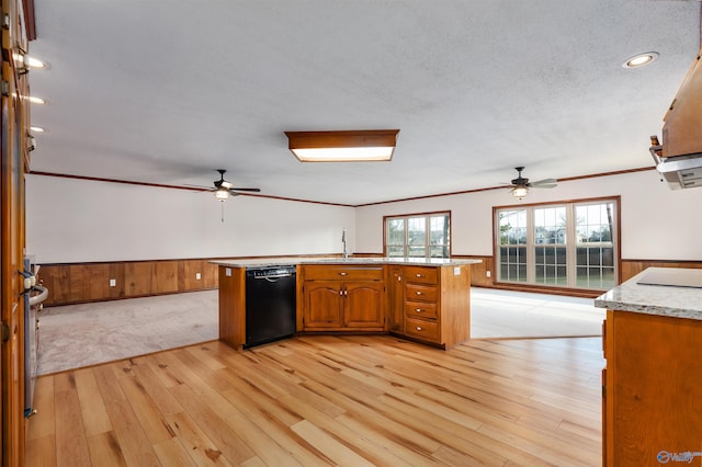 kitchen with crown molding, black dishwasher, sink, and light wood-type flooring