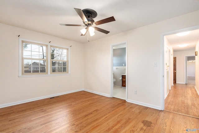 unfurnished bedroom with ensuite bathroom, ceiling fan, and light wood-type flooring