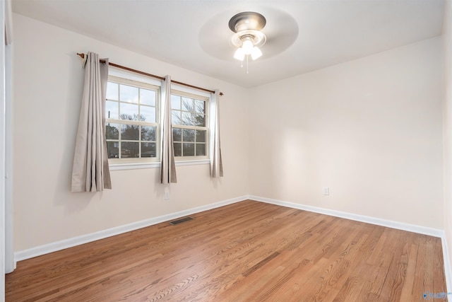 unfurnished room with ceiling fan and light hardwood / wood-style floors