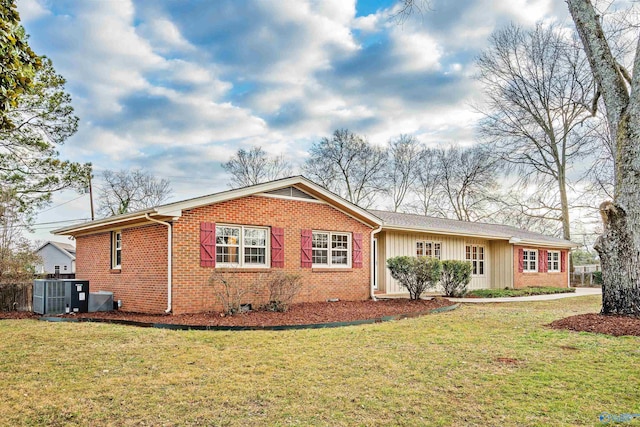 view of front of property featuring a front yard and central air condition unit