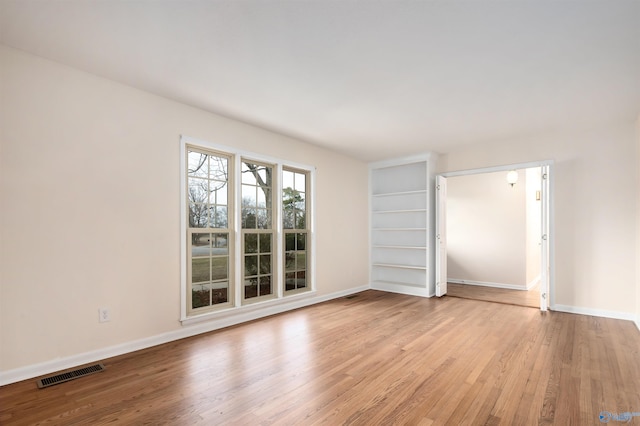 unfurnished room with light hardwood / wood-style floors