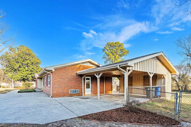 1300 Woodside Dr, Athens, AL 35611 - view of front of house with brick siding, a gate, concrete driveway, and a patio area