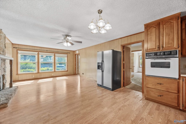 11303 Crestfield Dr, Huntsville, AL 35803 - kitchen featuring stainless steel refrigerator with ice dispenser, white oven, light wood-style floors, a ceiling fan, and a textured ceiling
