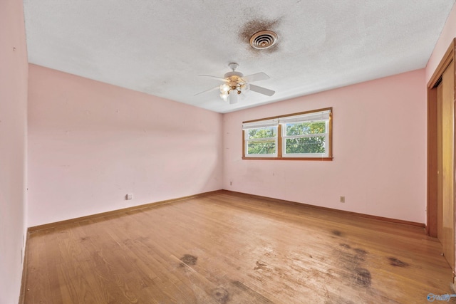 11303 Crestfield Dr, Huntsville, AL 35803 - spare room featuring light wood-style floors, ceiling fan, baseboards, and a textured ceiling