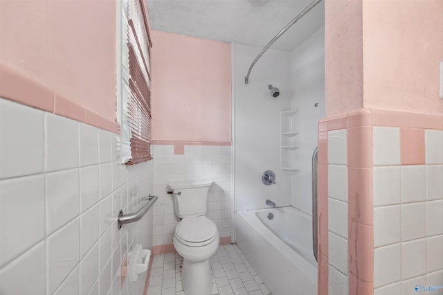 11303 Crestfield Dr, Huntsville, AL 35803 - full bathroom with shower / tub combination, toilet, tile walls, tile patterned floors, and a wainscoted wall
