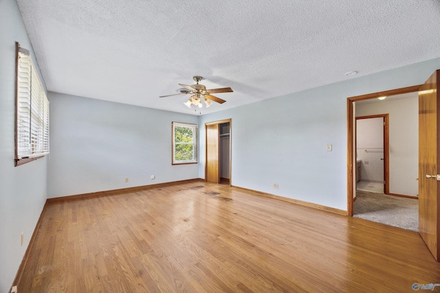 11303 Crestfield Dr, Huntsville, AL 35803 - empty room featuring light wood-style floors, a ceiling fan, a textured ceiling, and baseboards