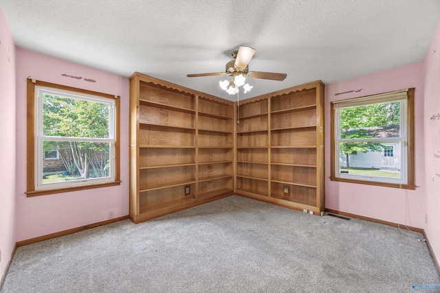11303 Crestfield Dr, Huntsville, AL 35803 - spare room featuring carpet floors, a textured ceiling, healthy amount of natural light, baseboards, and ceiling fan