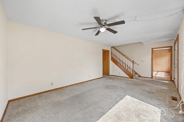 11303 Crestfield Dr, Huntsville, AL 35803 - unfurnished living room with carpet, a ceiling fan, stairway, and baseboards