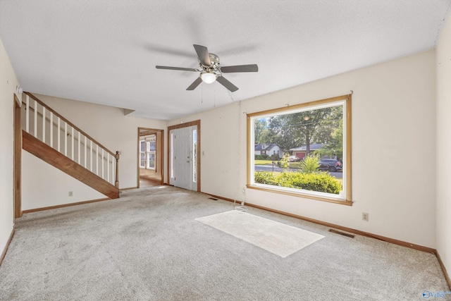 11303 Crestfield Dr, Huntsville, AL 35803 - unfurnished living room featuring stairs, ceiling fan, carpet flooring, and baseboards