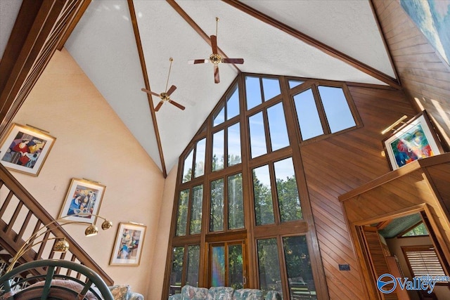 details with a textured ceiling, ceiling fan, and wooden walls