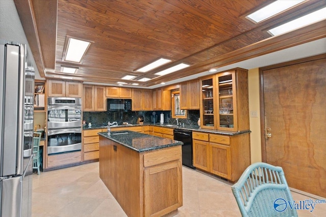 kitchen with black appliances, wood ceiling, a center island, decorative backsplash, and dark stone countertops