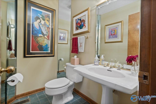 bathroom featuring toilet and tile patterned floors