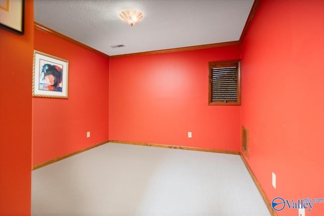 carpeted spare room with crown molding and a textured ceiling