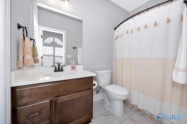 bathroom with vanity, curtained shower, marble finish floor, and toilet