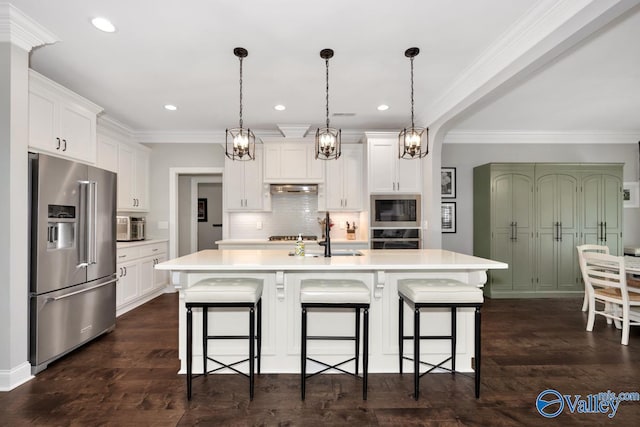 kitchen with a kitchen breakfast bar, under cabinet range hood, light countertops, decorative backsplash, and appliances with stainless steel finishes