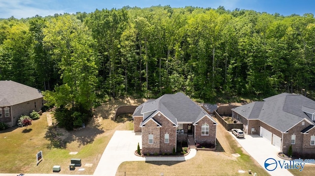 aerial view featuring a wooded view