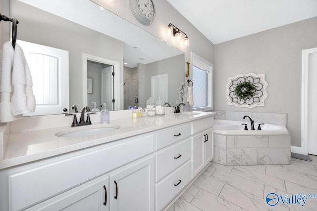 full bath featuring a shower stall, marble finish floor, a bath, and a sink