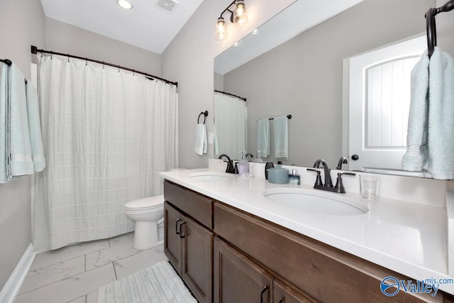 full bathroom featuring marble finish floor, a sink, visible vents, and double vanity