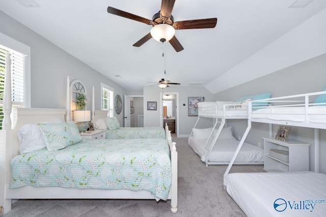 carpeted bedroom with vaulted ceiling and visible vents