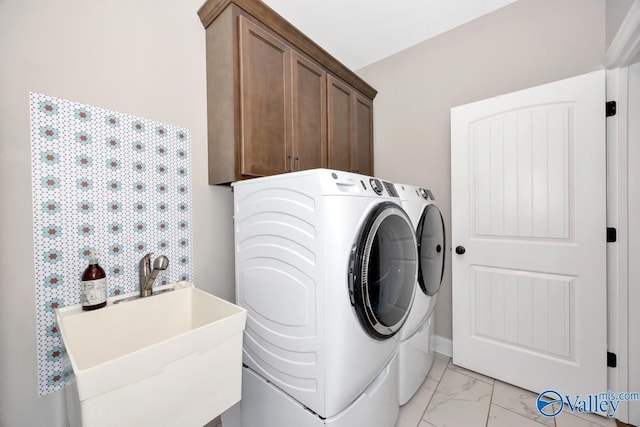 clothes washing area with separate washer and dryer, cabinet space, marble finish floor, and a sink