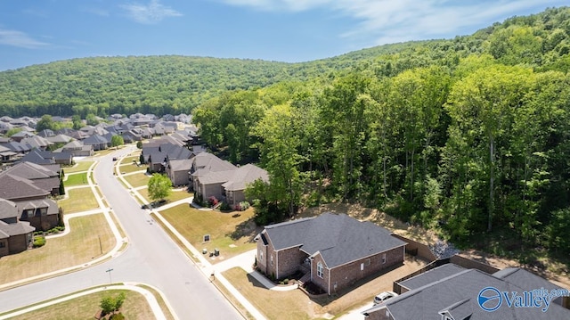 bird's eye view featuring a forest view and a residential view