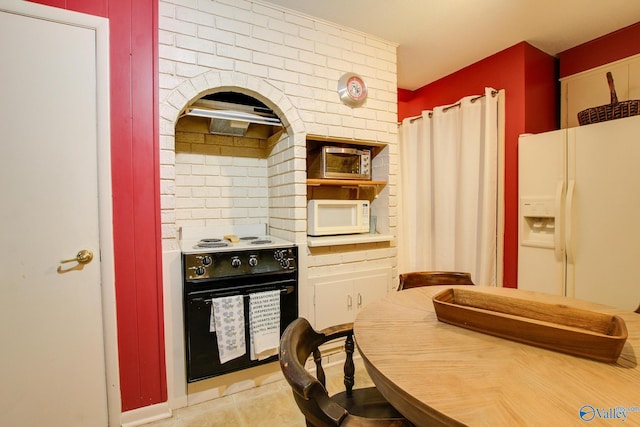 kitchen with white appliances and light tile patterned floors