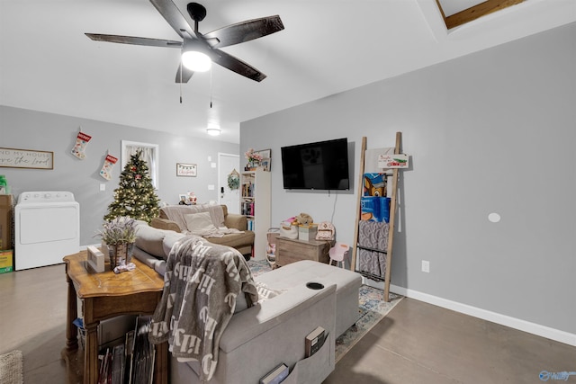 living room with concrete flooring, washer / clothes dryer, and ceiling fan