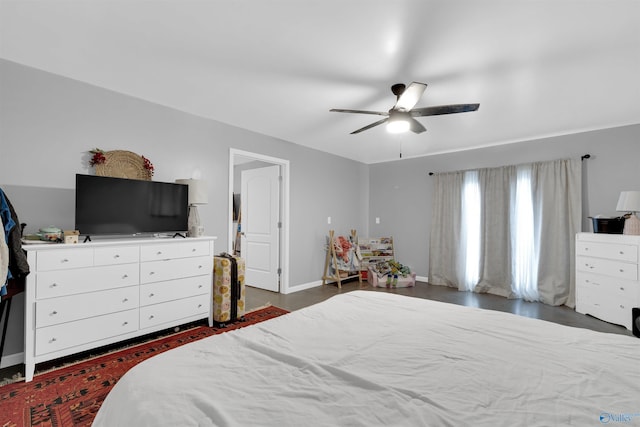 bedroom with dark hardwood / wood-style floors and ceiling fan