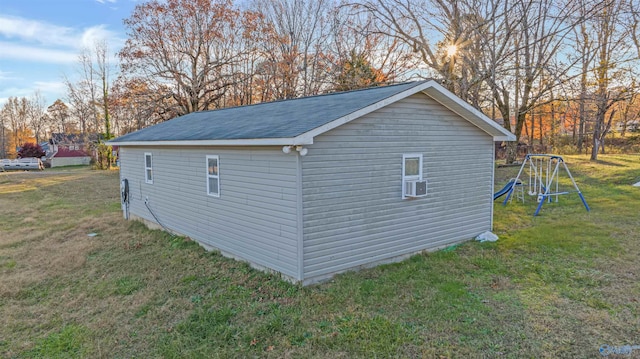 view of side of home featuring a playground, cooling unit, and a yard